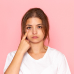 1790663247_front_view_young_beautiful_female_white_shirt_showing_her_eye